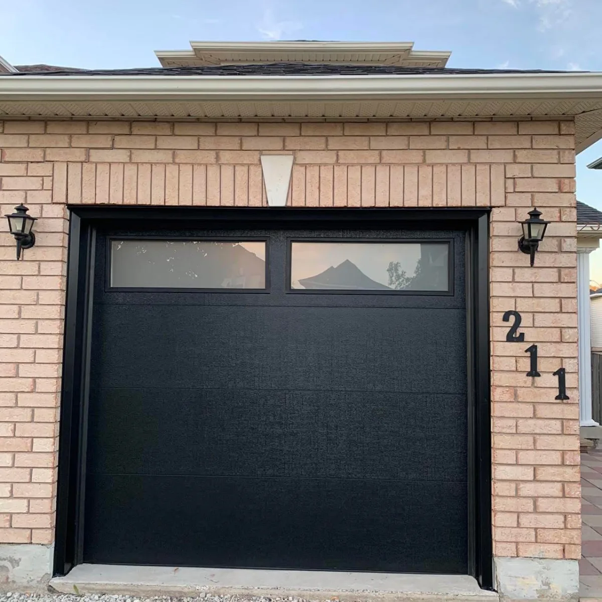 Black garage door at dusk